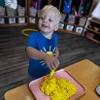 child playing with playdough
