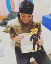 A student poses with their acceptance letter.