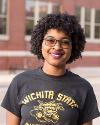 A student poses wearing a Wichita State Shockers shirt.