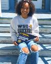 A seated student holds a mini WSU pennant.