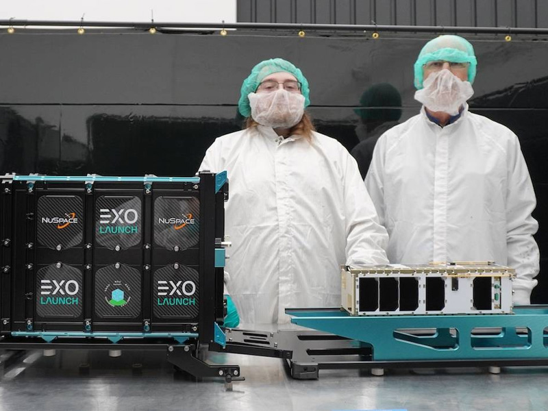 Wichita State University graduate student Brian Doty (left) and Brian Sutin, a retired scientist with NASA's Jet Propulsion Laboratory, are pictured with WSU's CubeSat, known as SNAPPY (Solar Neutrino Astro-Particle PhYsic).