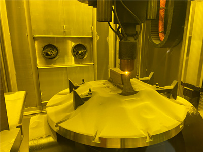 image of a metal 3D printer printing an object inside the machine