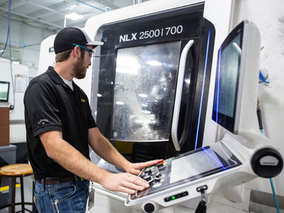 NIAR employee working at a CNC machine