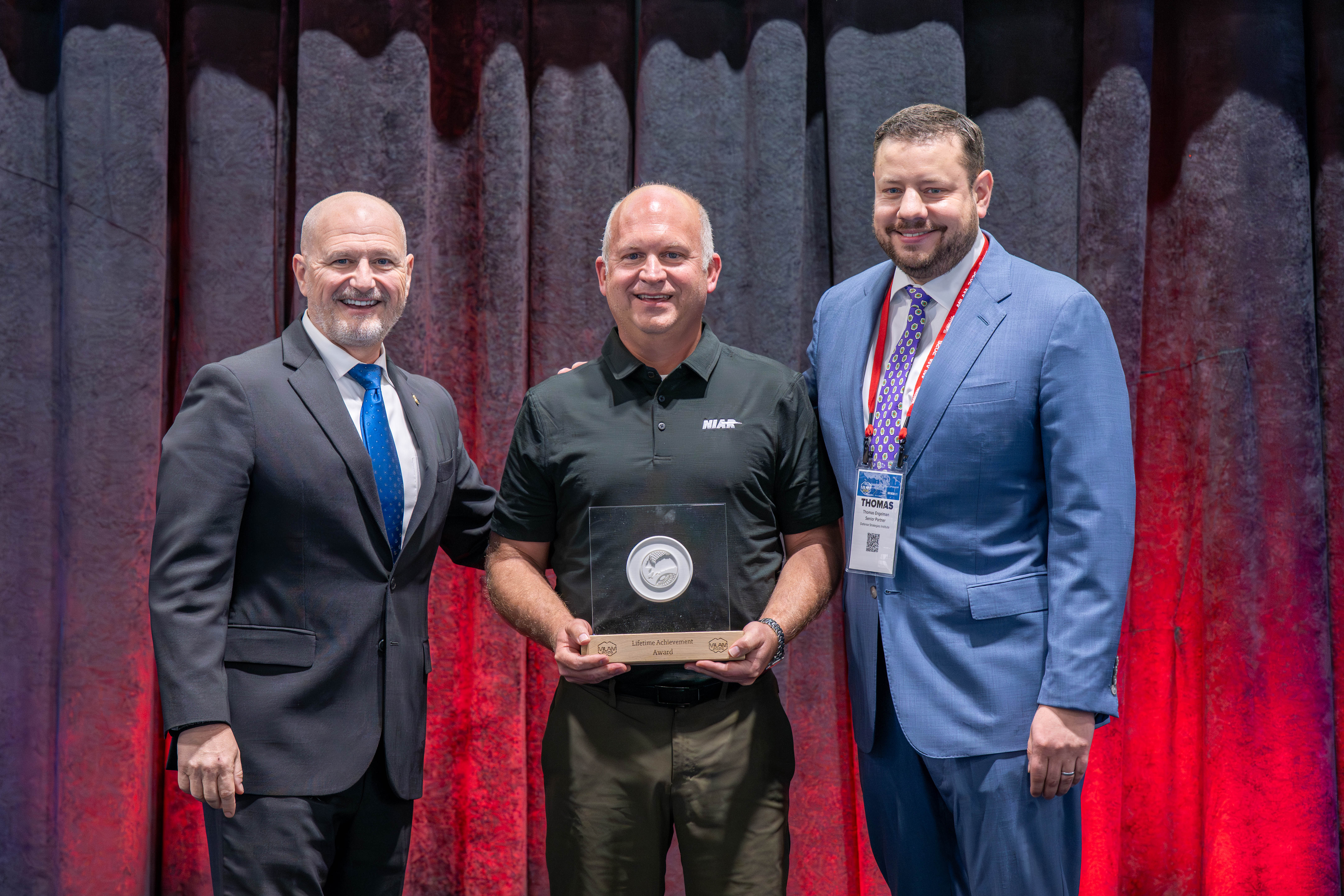 John Tomblin accepting the MILAM Lifetime Achievement Award from General Ed Daly and Thomas Engleman of Defesne Strategy Institute 