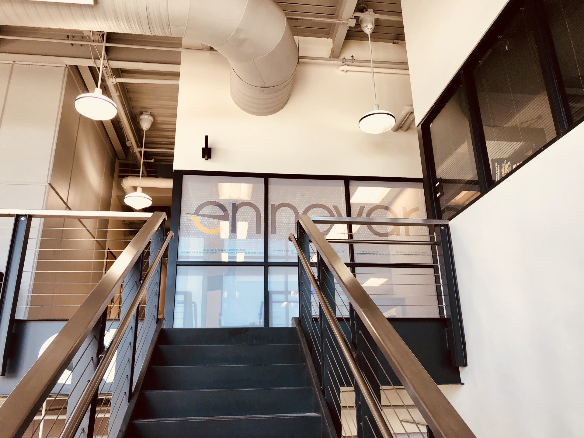 Staircase leading to a room with an Ennovar logo