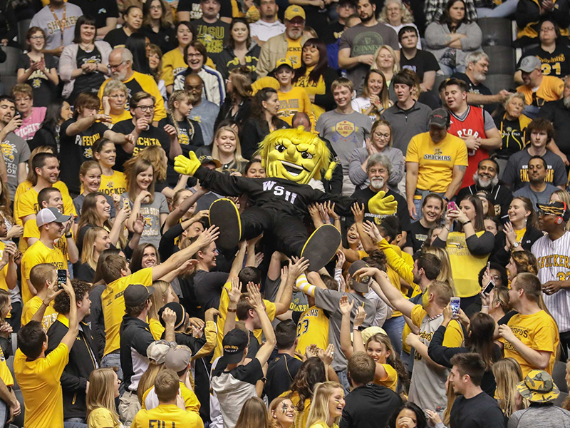 WSU mascot WuShock crowdsurfing during a basketball game