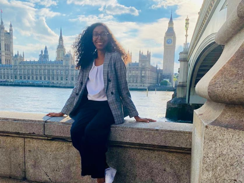 Photo of Chazni Caesar sitting on a bridge in London