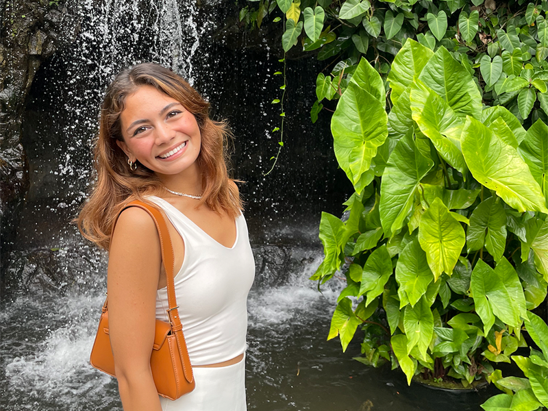 Photo of Hannah Harpel in front of a waterfall