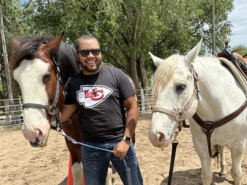 DaVontae Clemons leading 2 horses