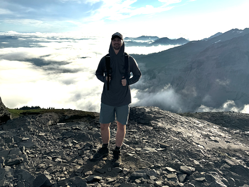 Photo of Andrew Gross hiking on a mountain