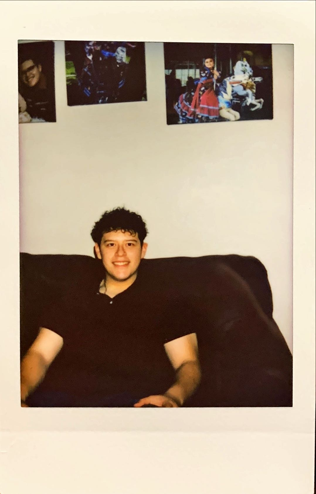 A polaroid photo of Carlos Rangel sitting down in a living room