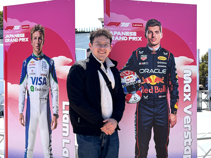 Photo of Carlos Rangel in front of Formula 1 posters