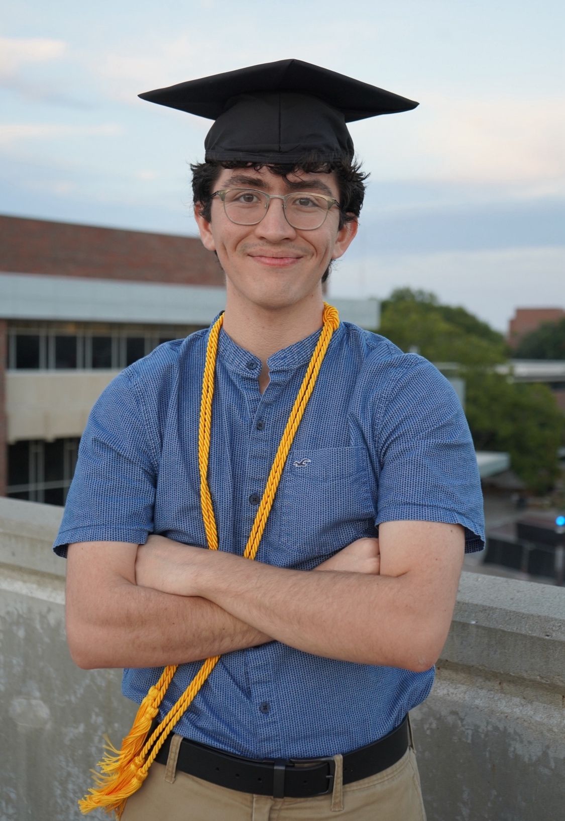 Photo of Santiago Diaz with a graduation cap and cord