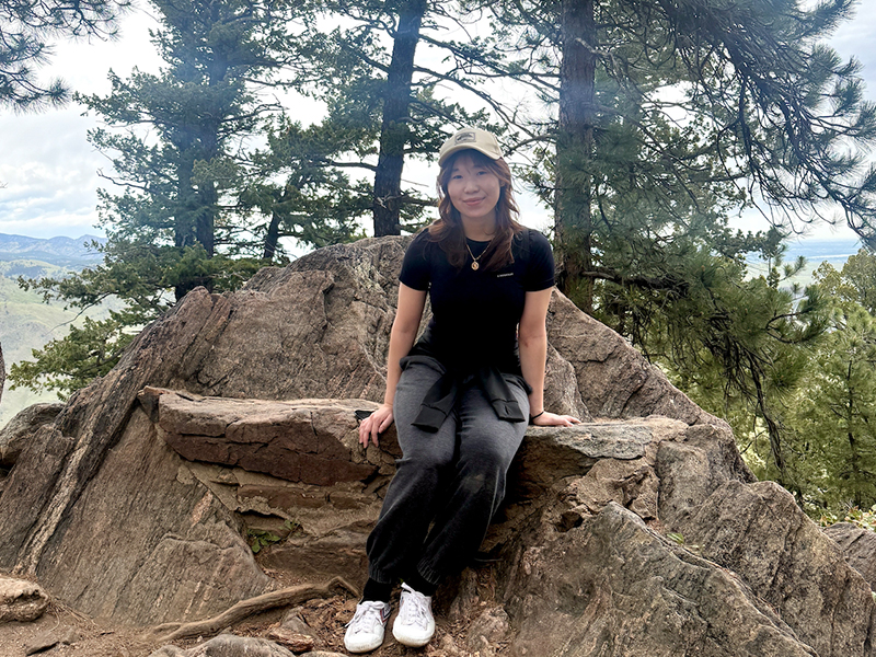 Photo of Christine Tran outside on a hiking path
