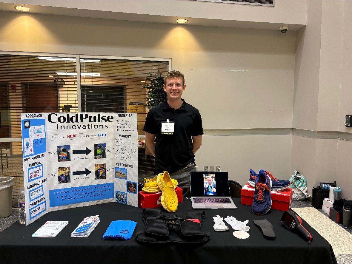 Photo of Adam Key in front of their Shocker New Venture presentation