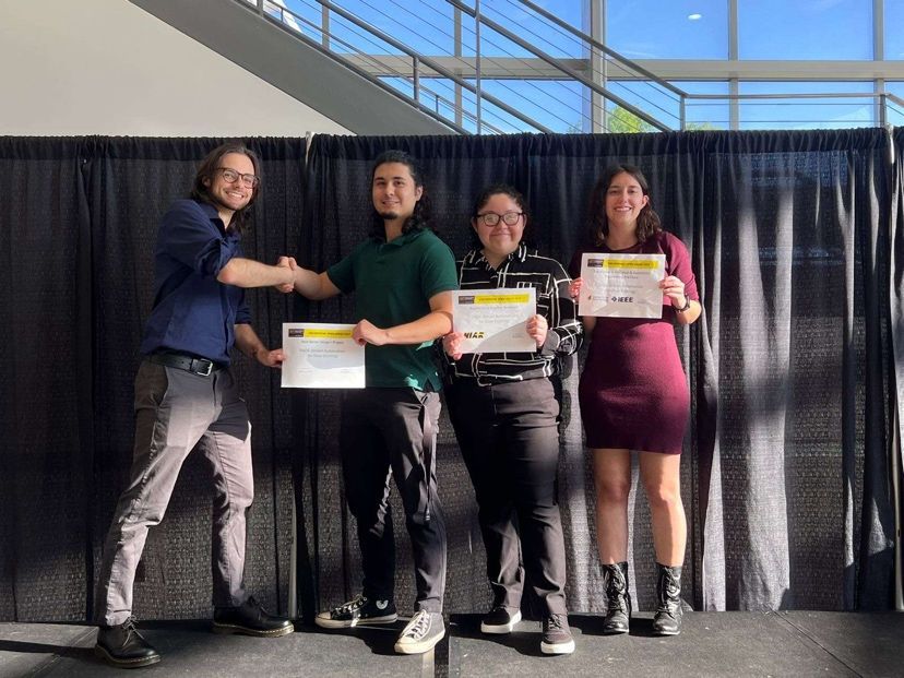 Photo of Emily Knudnes and their senior design project team recieving an award at the WSU Engineering Open House