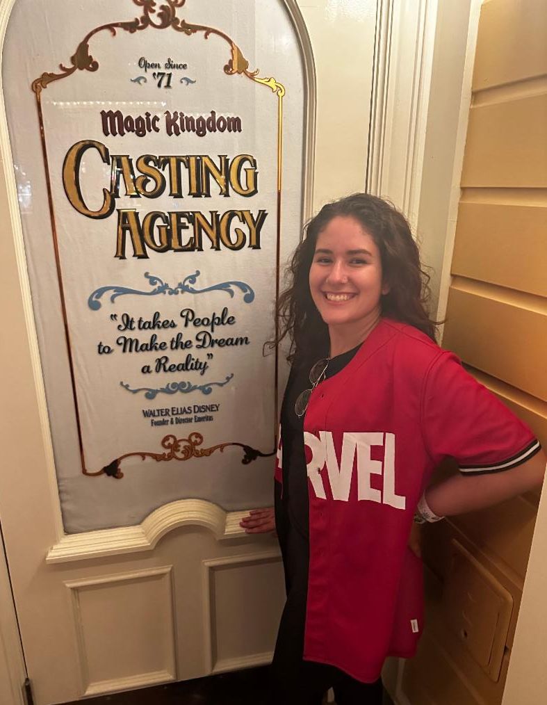 Photo of Tiahna Padilla in front of Disney World casting agency sign