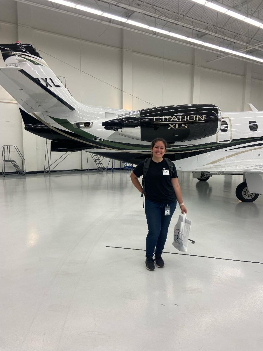Photo of Tiahna Padilla in front of a Citation jet
