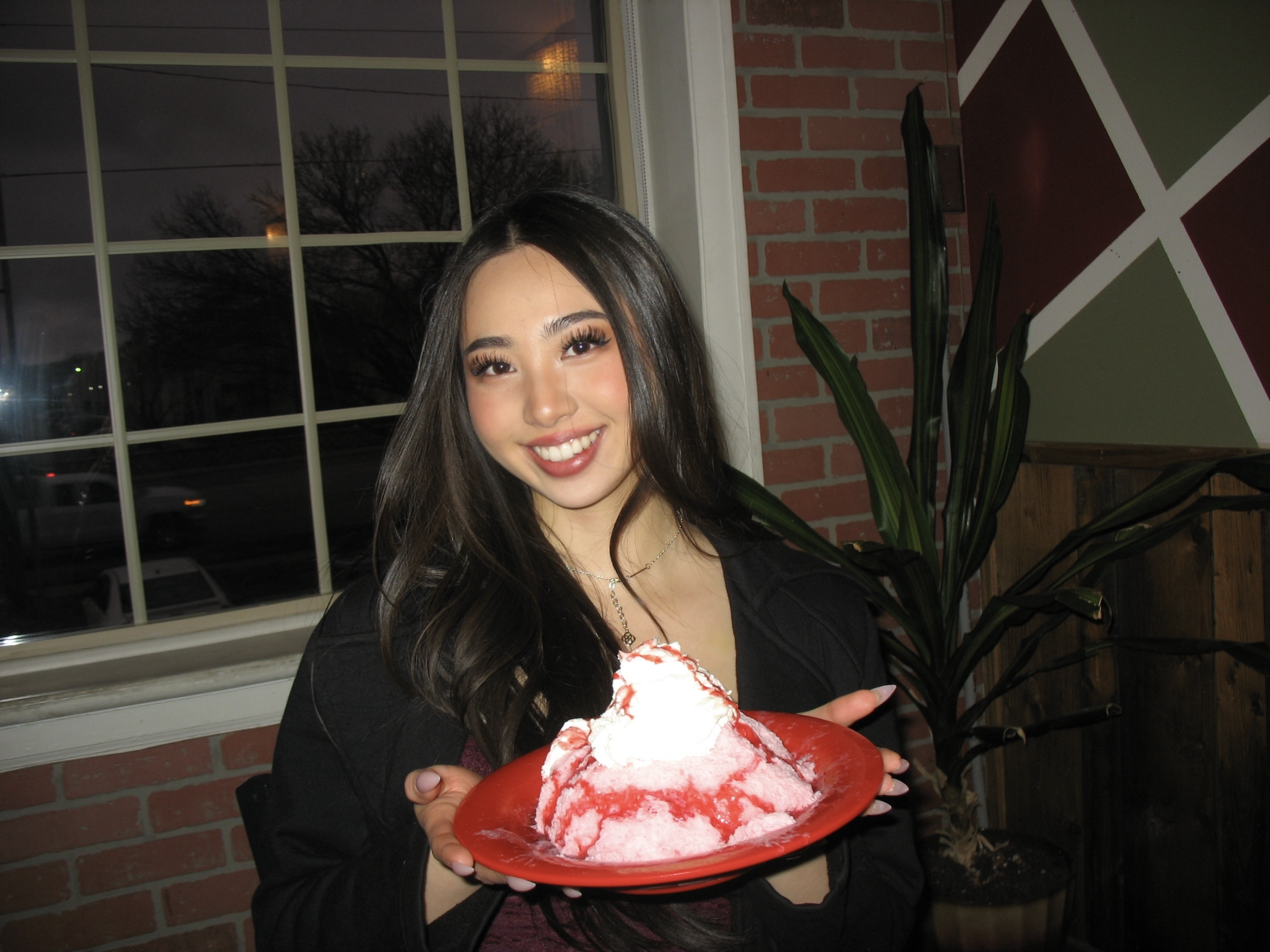 Photo of Jenny Ho with a large plate of shaved ice with red syrup