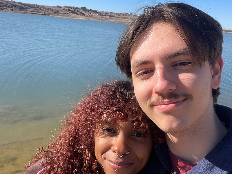 Photo of Mark Common and one other in front of a lake.