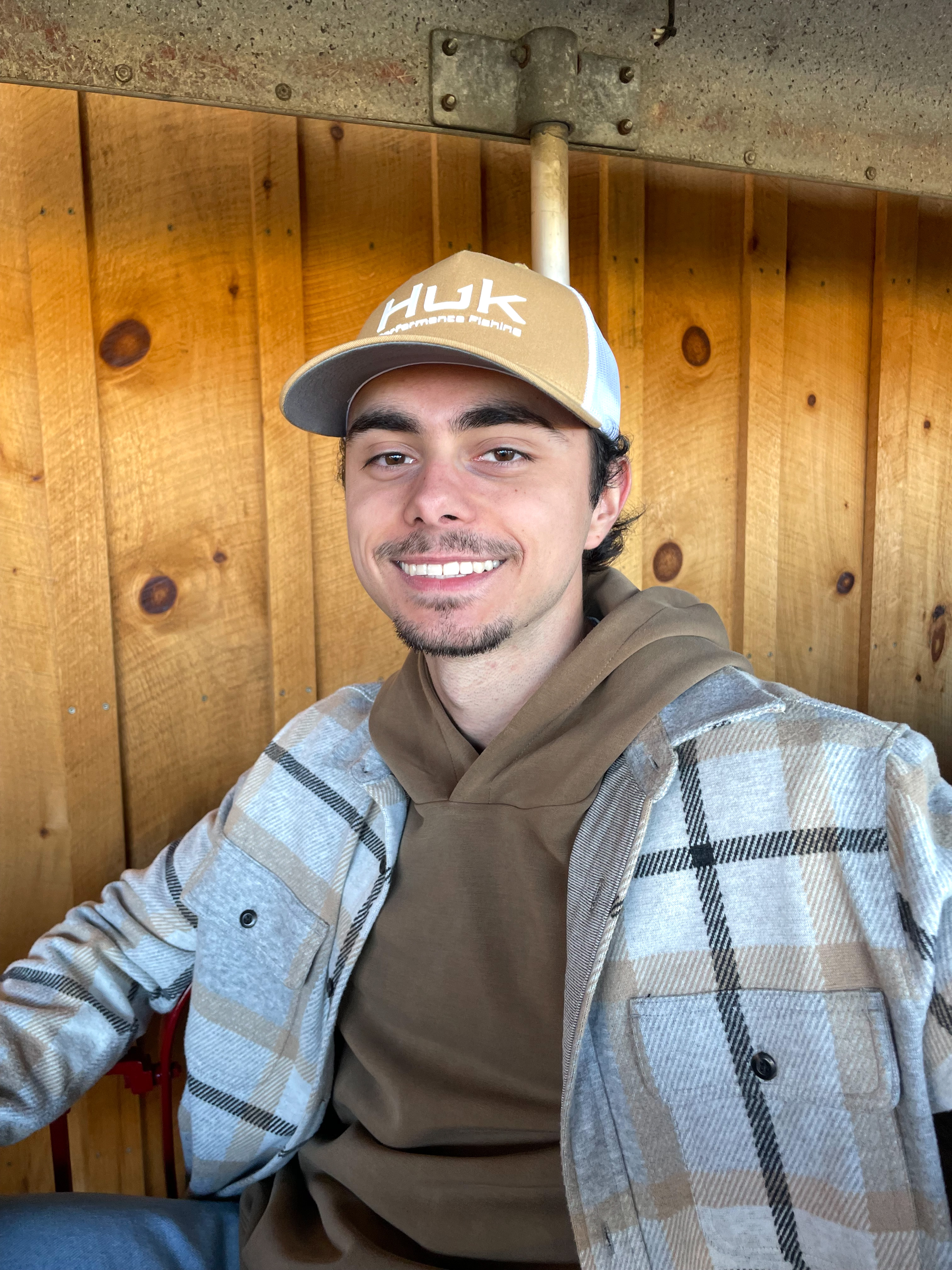 Photo of Layne Graves in casual clothing in front of a wooden door
