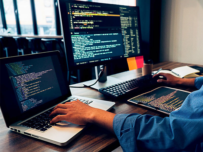 person at a computer doing coding