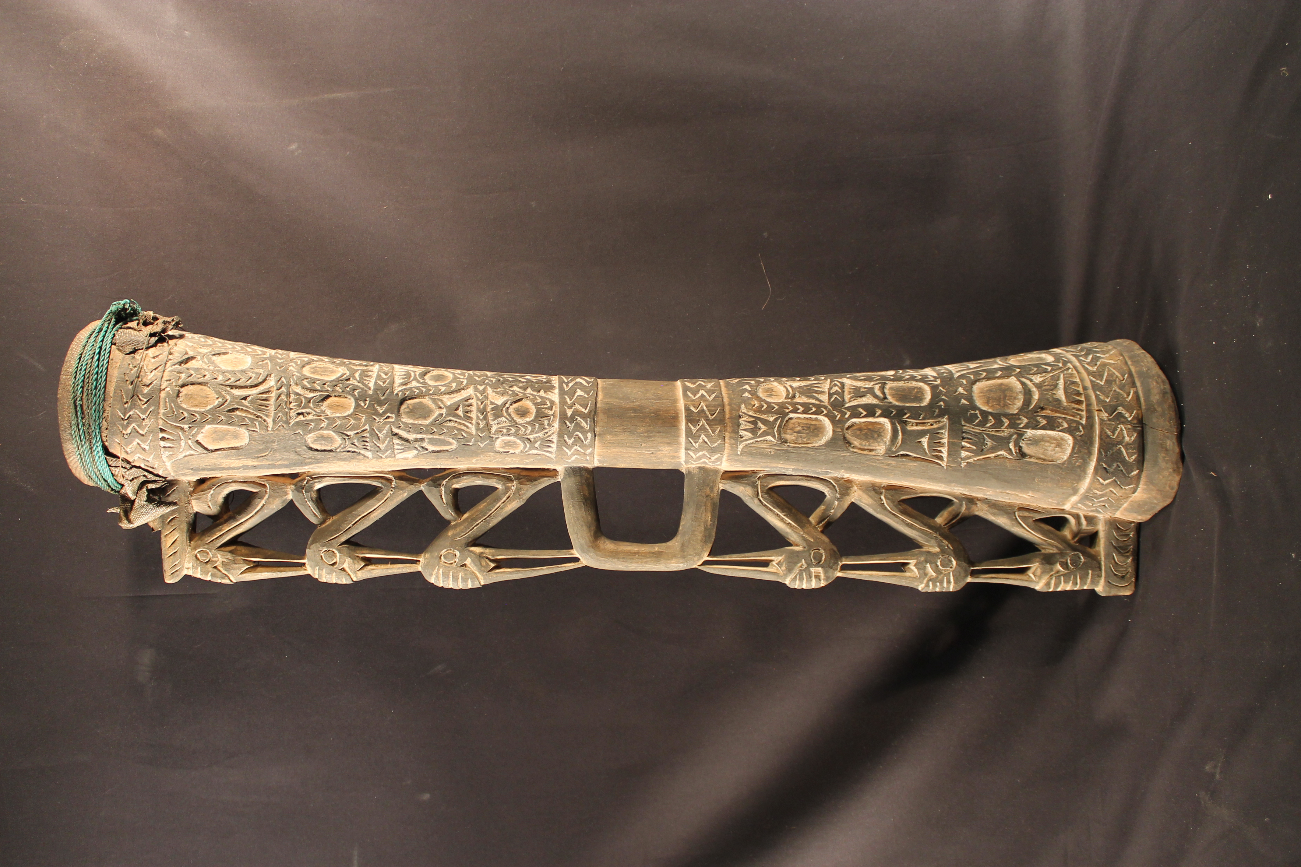 Carved wooden drums with lizard skin covering the head of the drum