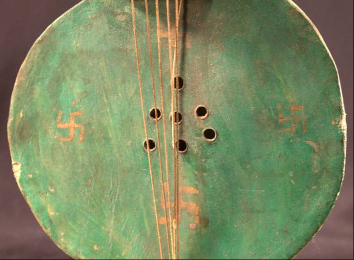 A close-up of the base of the instrument that better shows the four golden swastikas on the base.