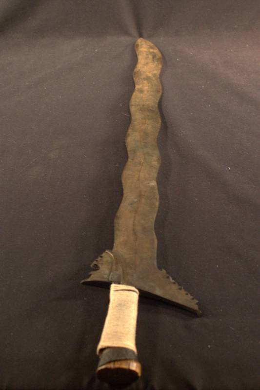 Steel blade with a wave shape and wooden handle.