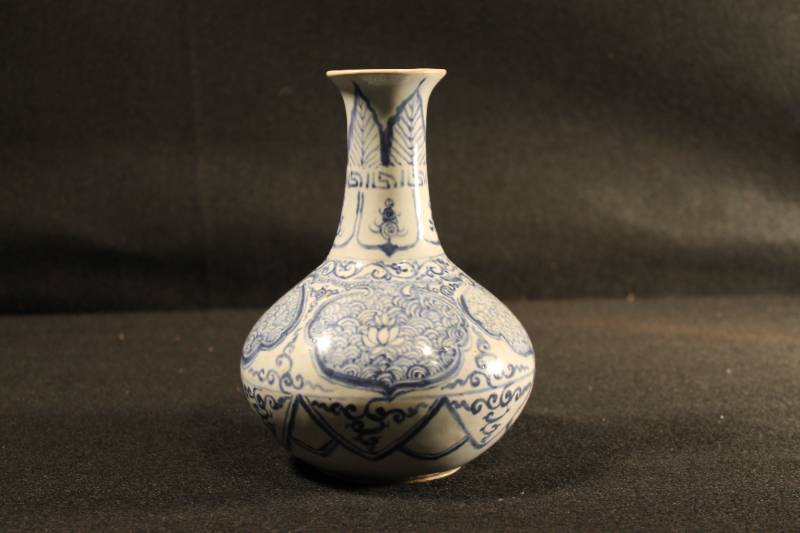 Medium sized urn/bottle with exceptionally fine blue and white swirl decoration that sets this Imperial ware apart. Glazed bottom is marked off center with six character mark.