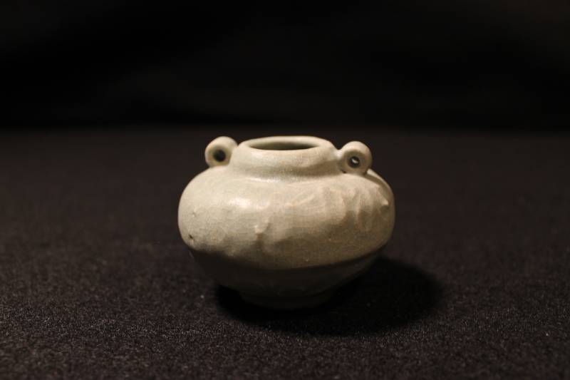 Small light green Celadon jarlet with lug handles, decorated with an underglaze peony design.