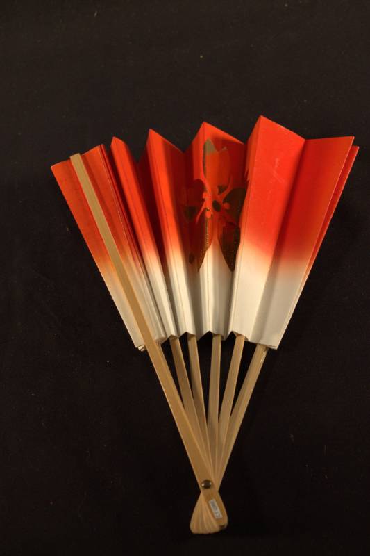 Fan frame is light colored bamboo, paper portion is a transition from white to bright red from the center outward with gold colored single flower design that is on both sides of the fan.