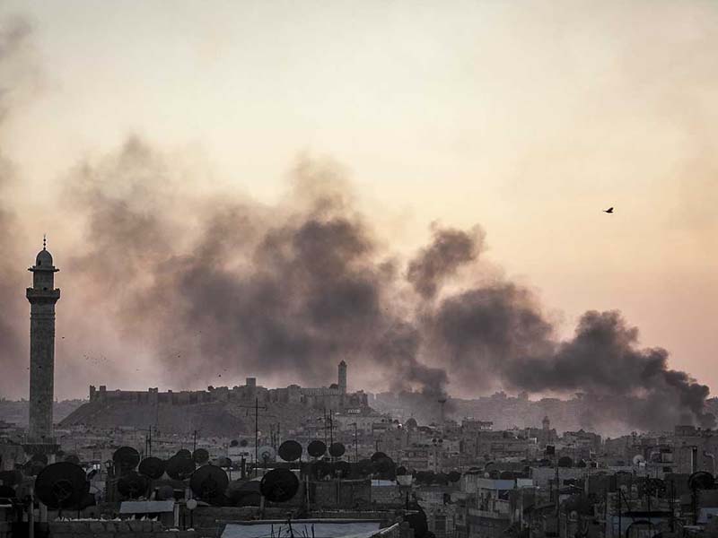 Smoke rises over the city of Aleppo