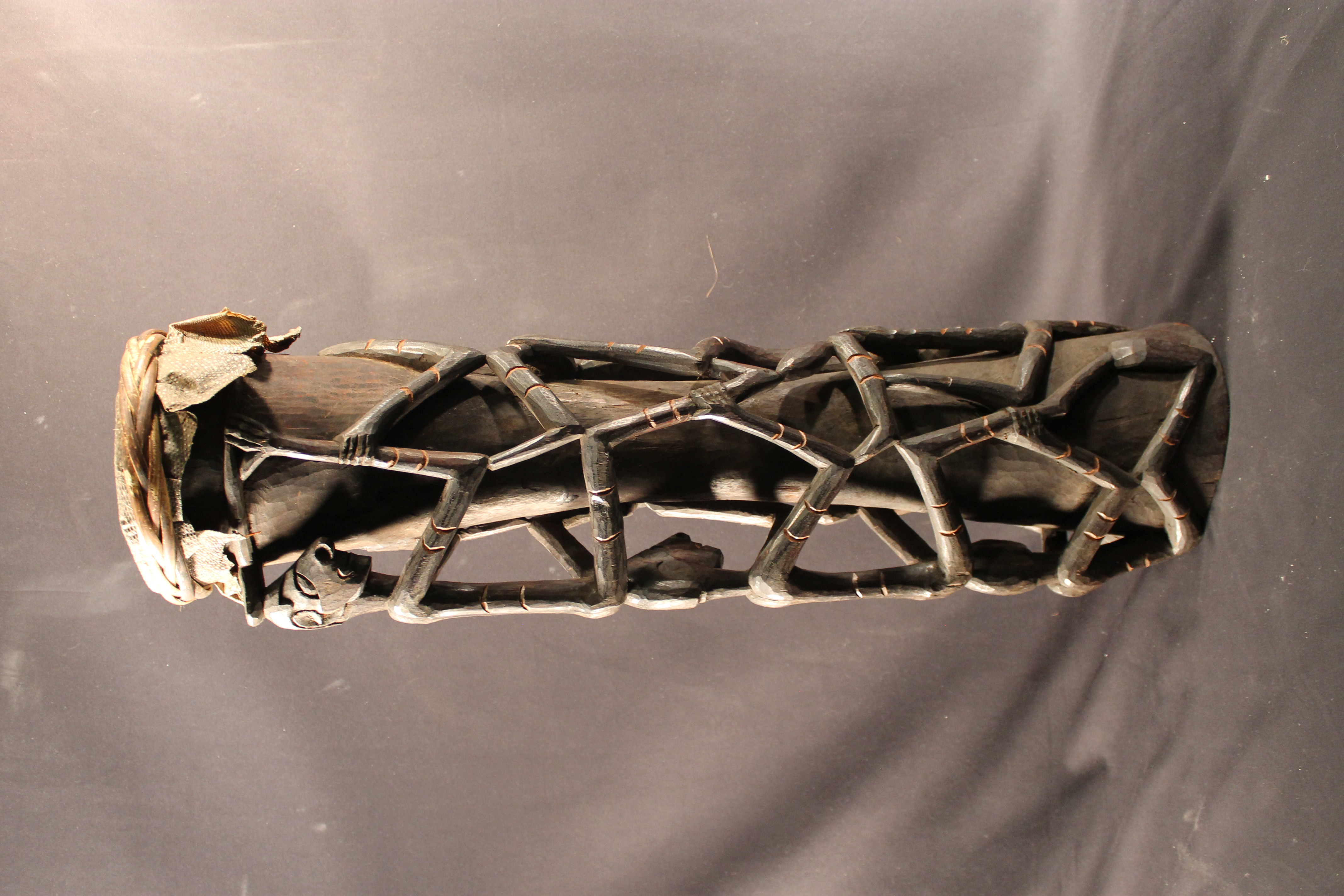 carved wooden drums with lizard skin covering the head of the drum