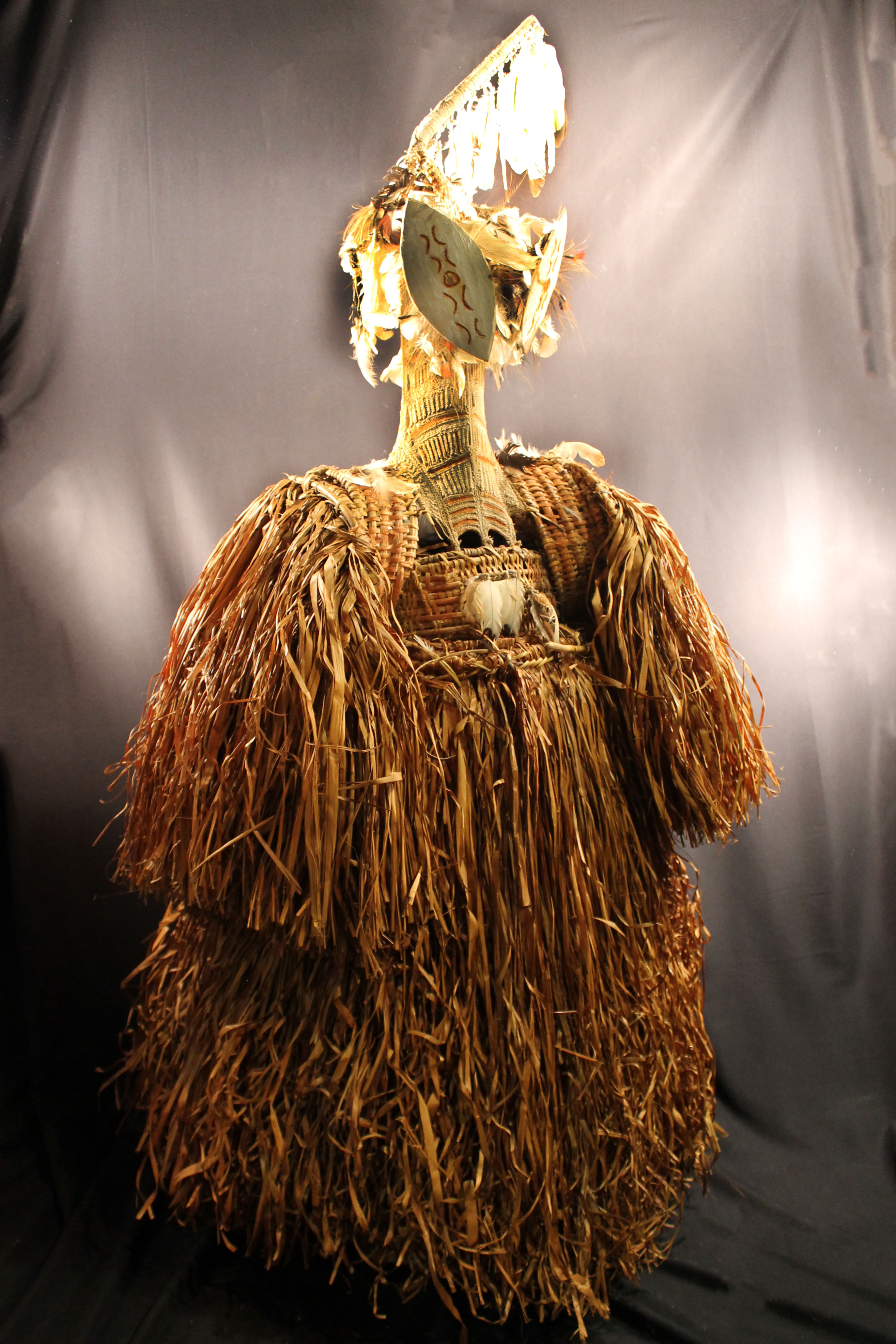 Woven body masks that has a grass skirt and sleeves with striped brown and white design on the center.