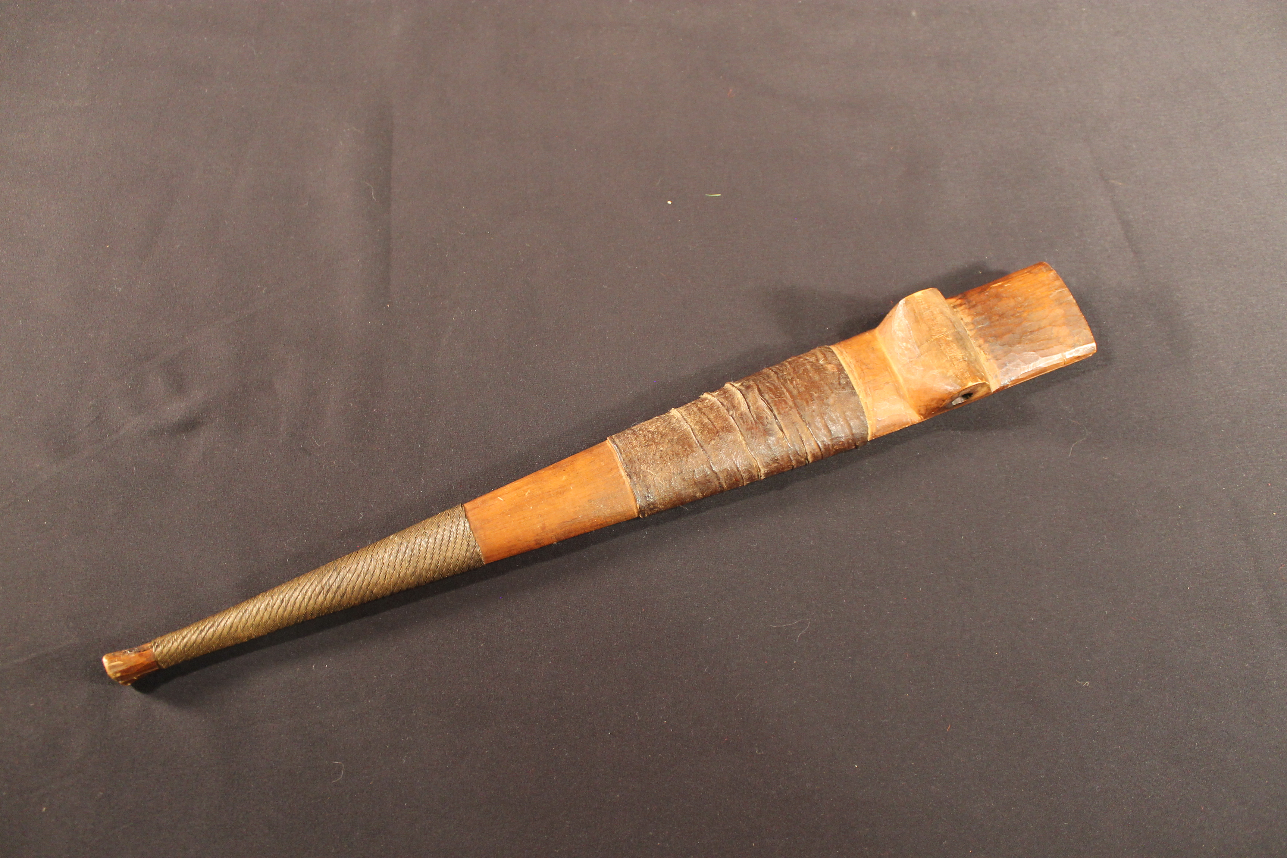 Sheath made of two wooden slats held together in the center by rawhide band and copper wire.