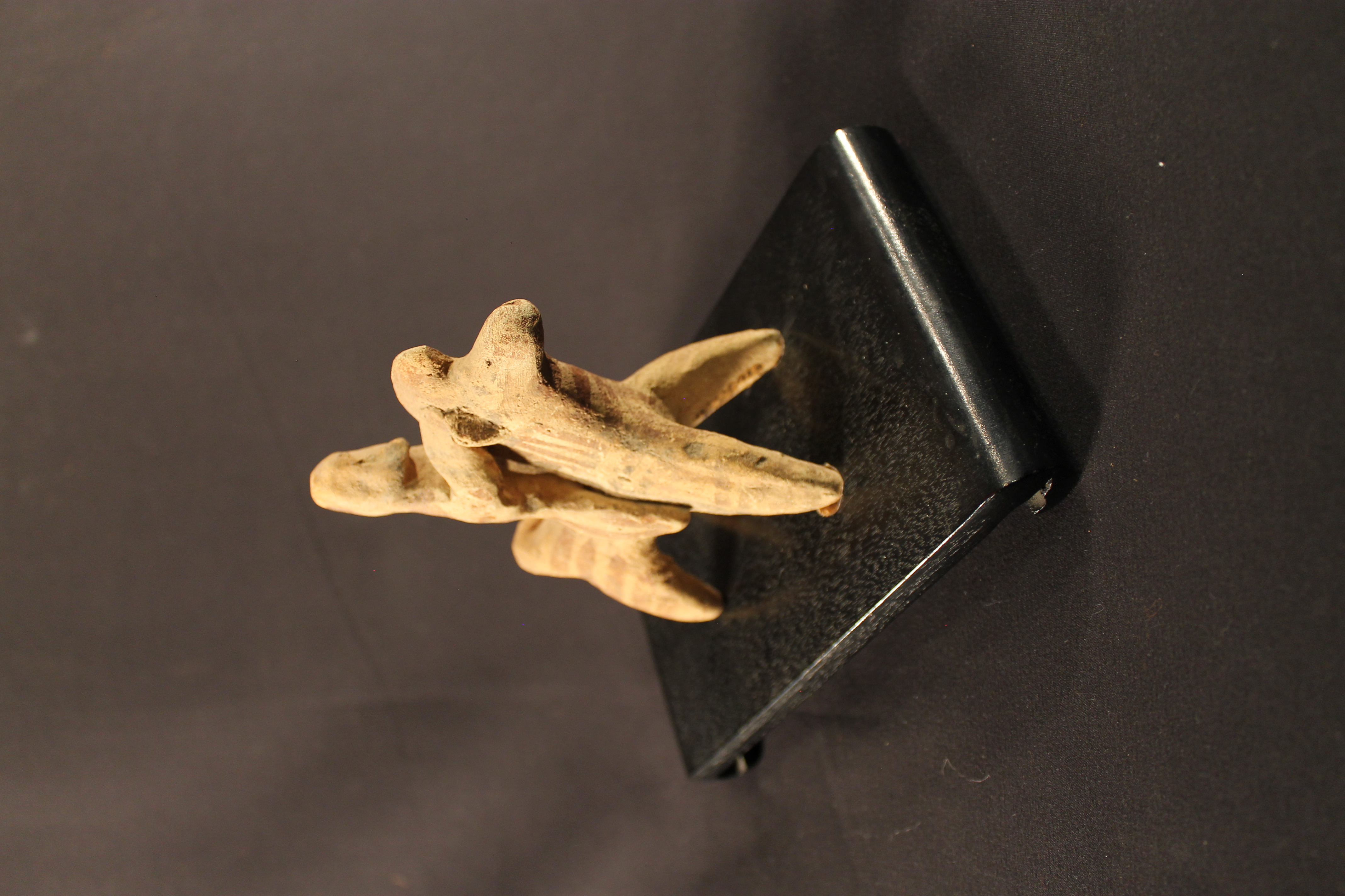 Human riding horse figurine. Brown and black patterns on the figurine are fading.