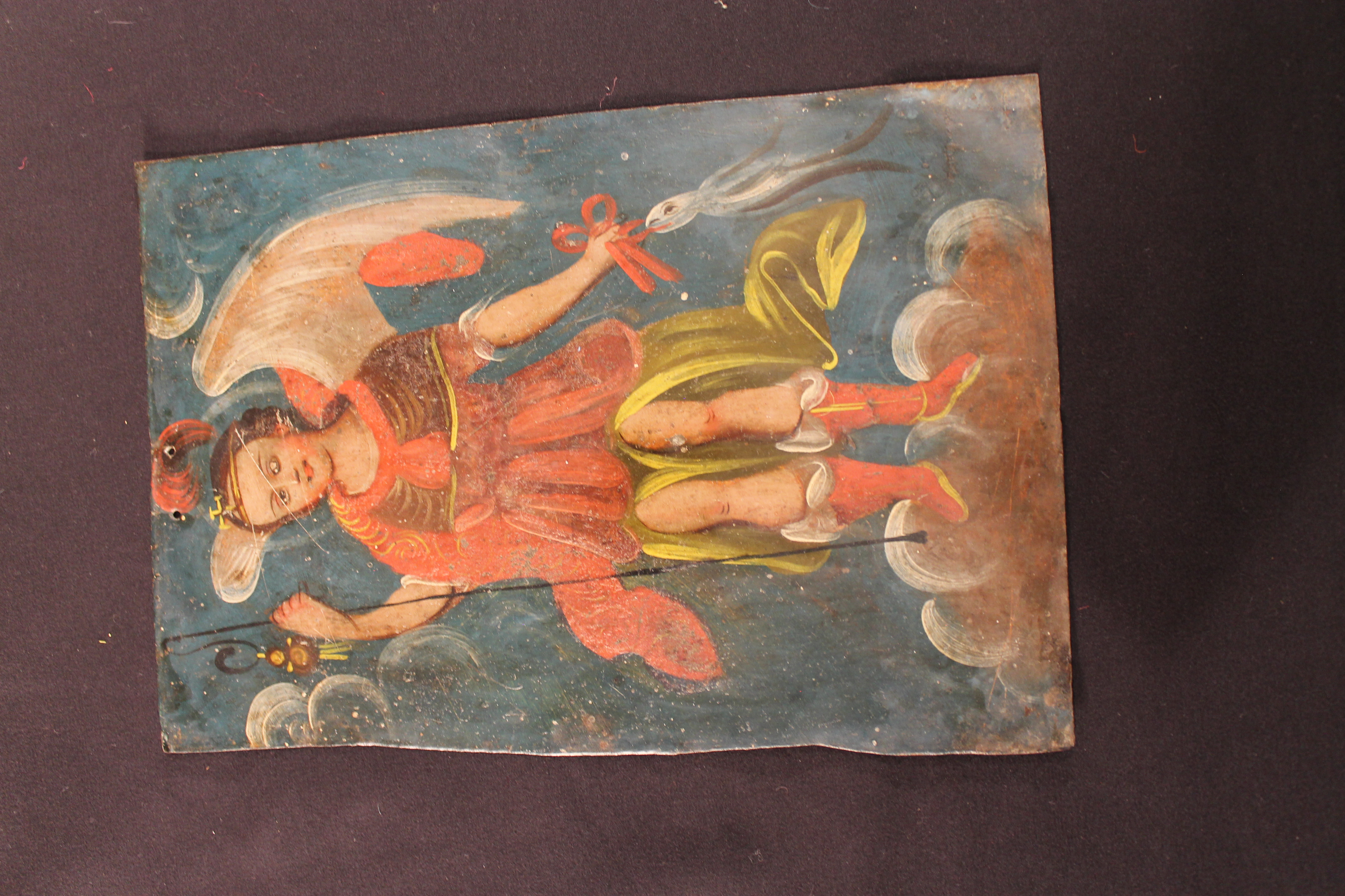 Retablo painting on tin of San Rafael standing on a cloud.