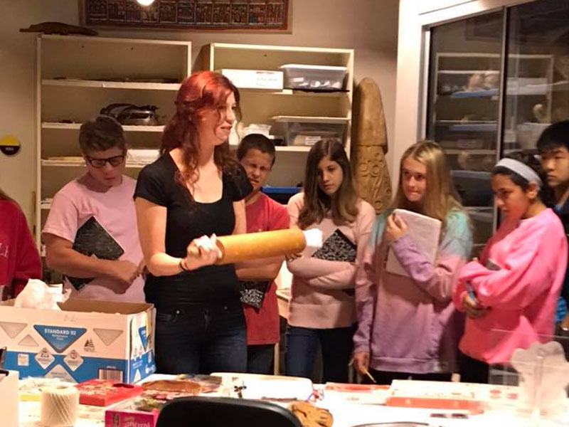 Museum student giving a tour to a school group 