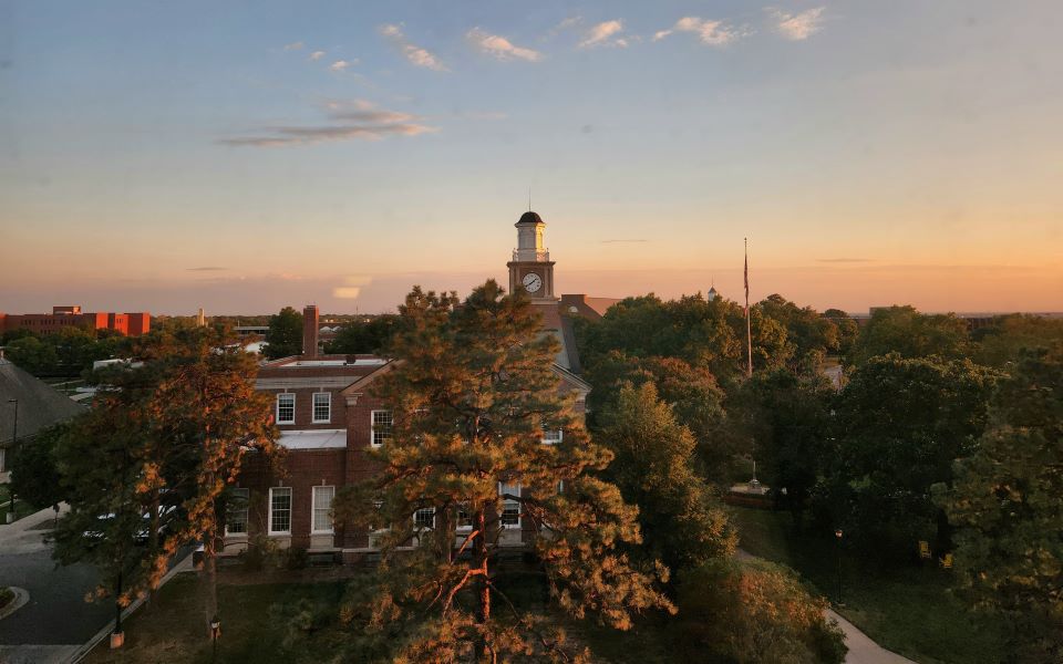 Aerial view of Morrison hall with setting sun.