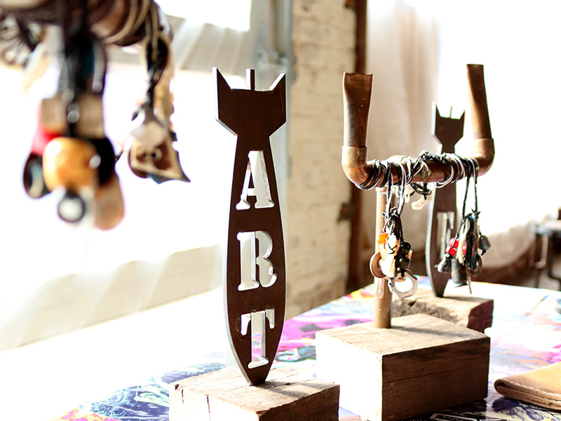metal art and jewelry on wooden blocks