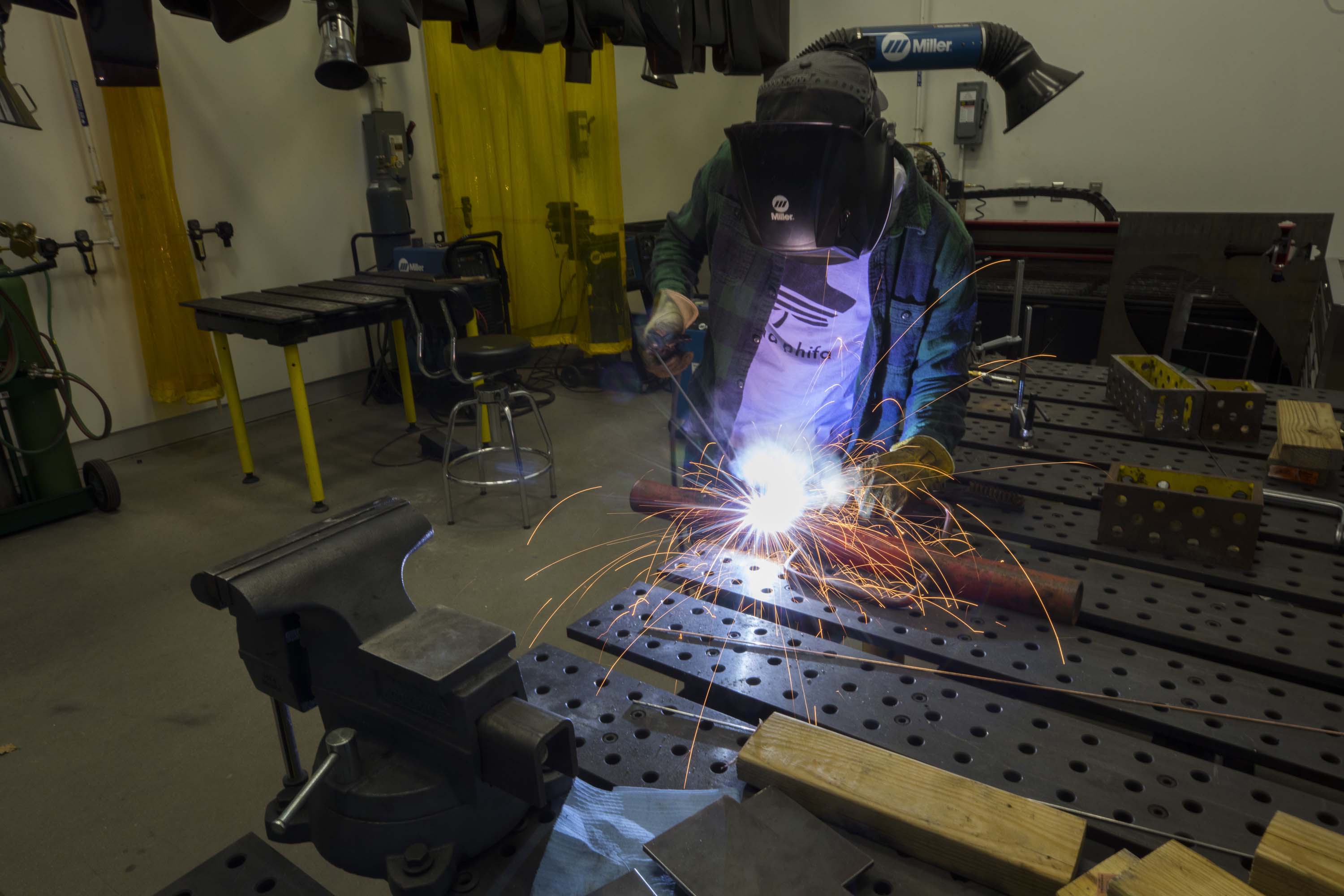 person welding metals with sparks flying