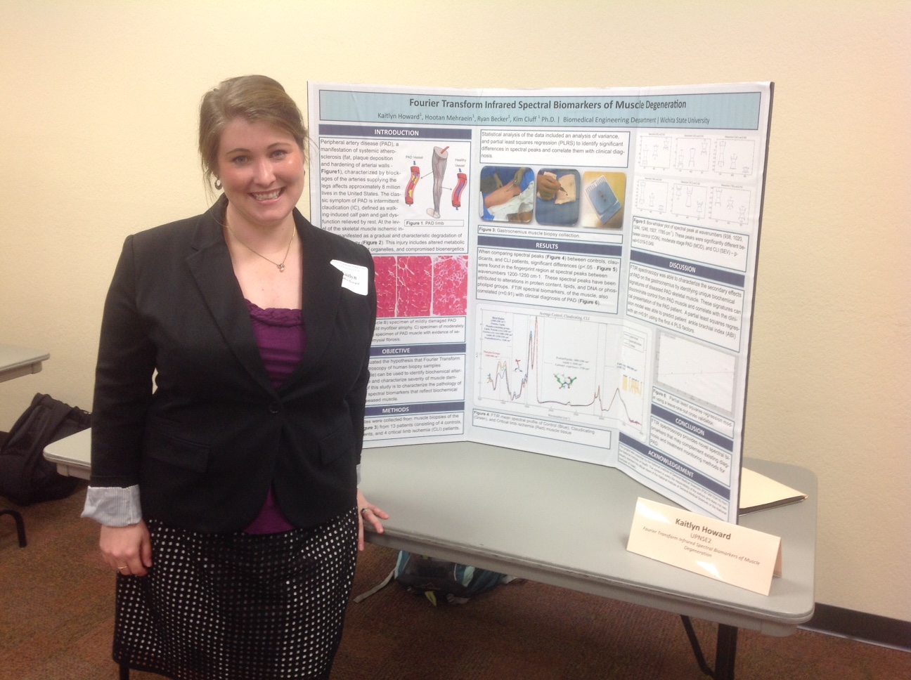 A woman with a posterboard presentation about muscle degridation