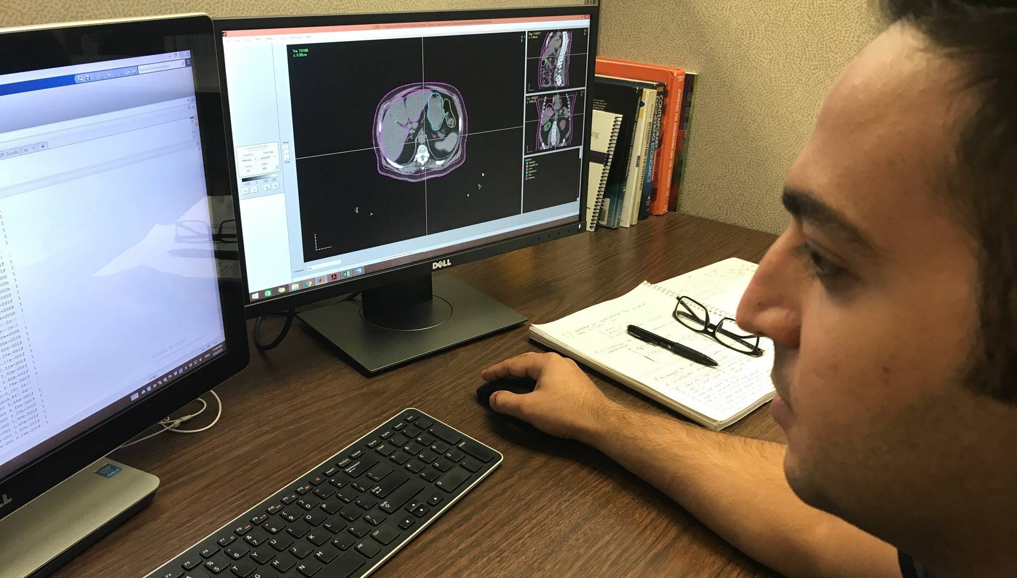 Student working on computer model of  tumor. 