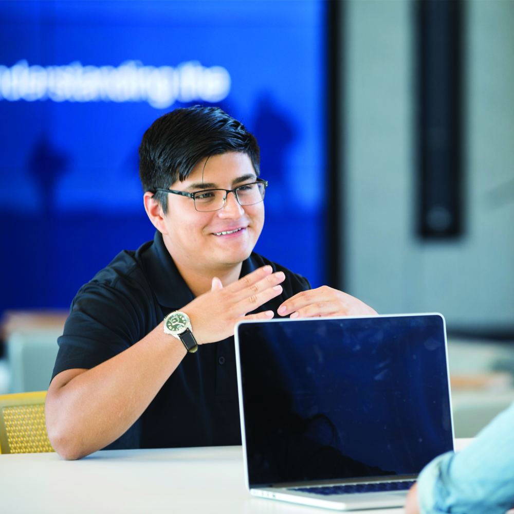 Man smiling and gesturing as if explaining something