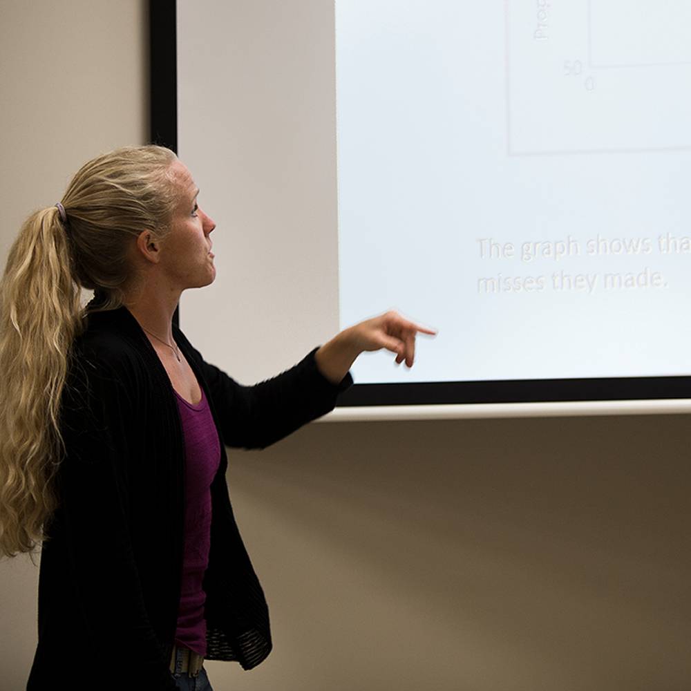 Woman pointing at projector screen