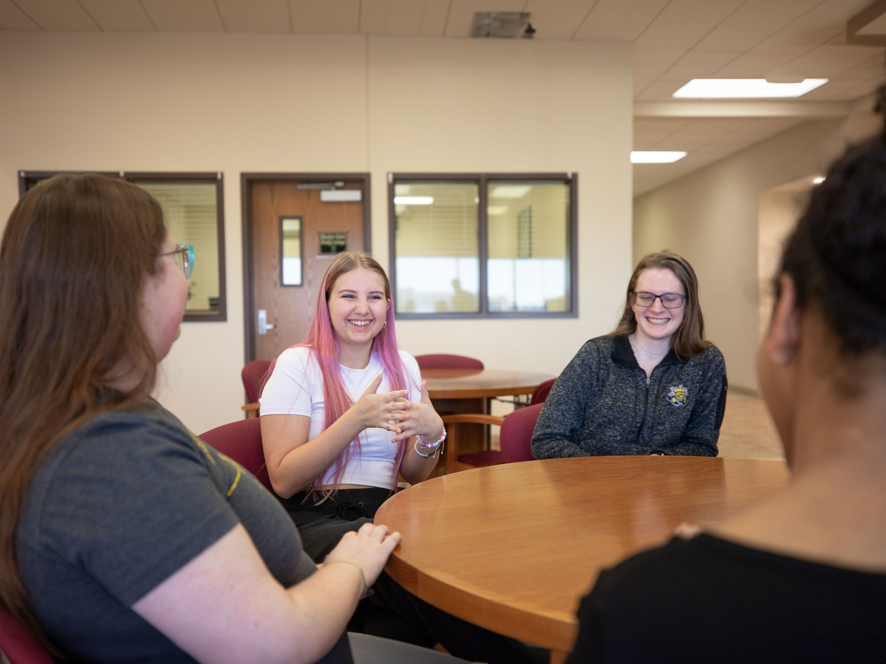 A group of students conversing in American Sign Language.