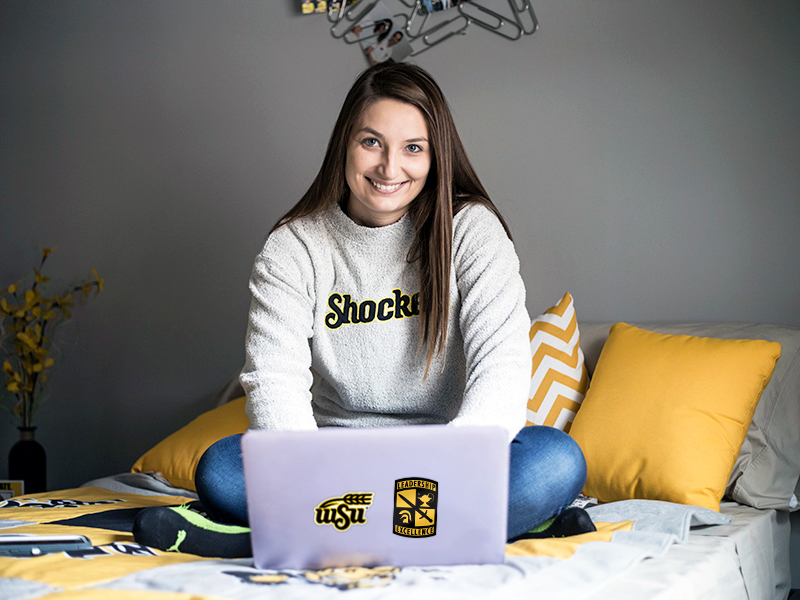 Student on laptop in The Flats.