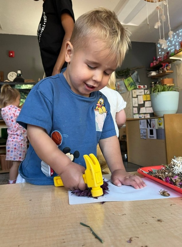child using a play hammer