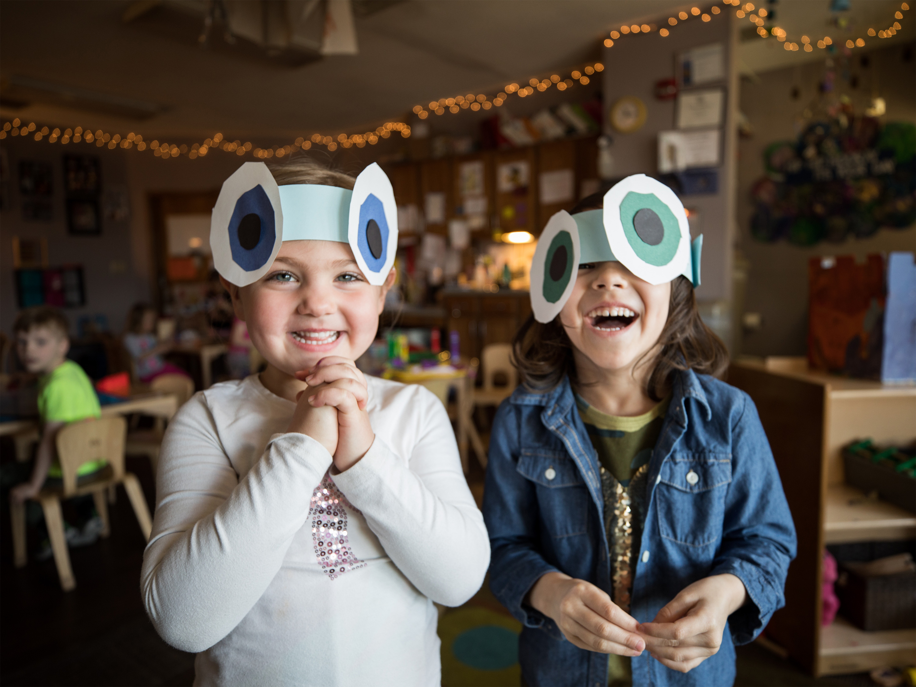 Two children wearing paper hats